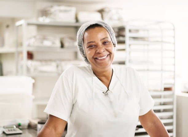Portrait of a professional senior female confectioner working in chocolate factory