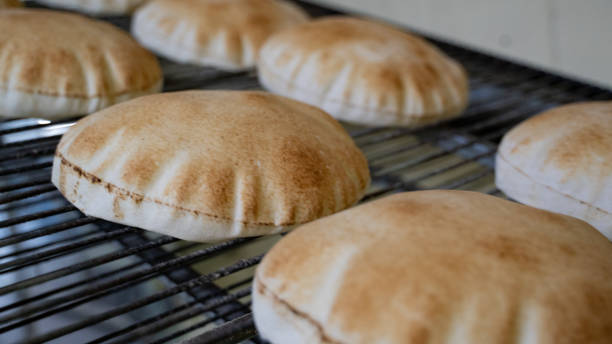 Background image of arabic bread produced in a machine.Arabic bread production